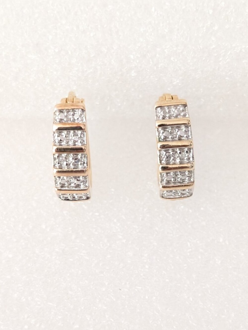 Small gold and silver huggie oval hoop earrings